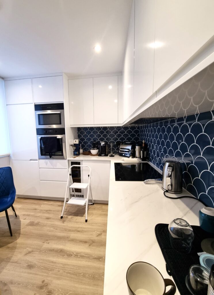 Modern White Kitchen with Blue Accent